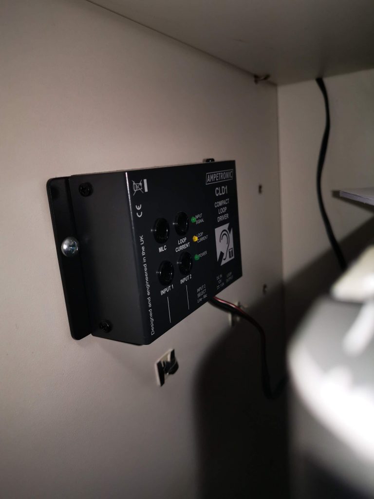 Picture of an ampetronic hearing induction loop controller being installed
